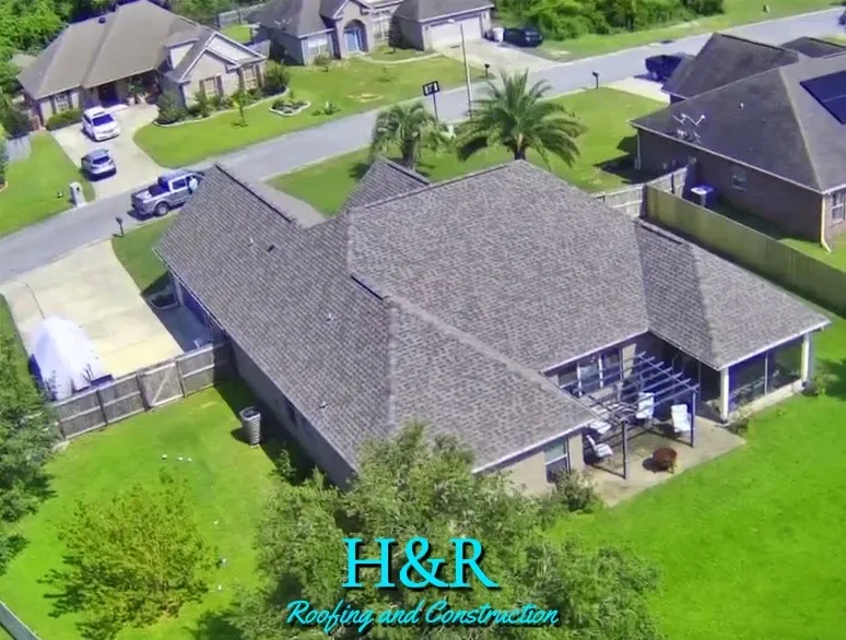 Aerial view of large home with gray hip shingle roof and screened back porch in Navarre FL by H&R Roofing and Construction