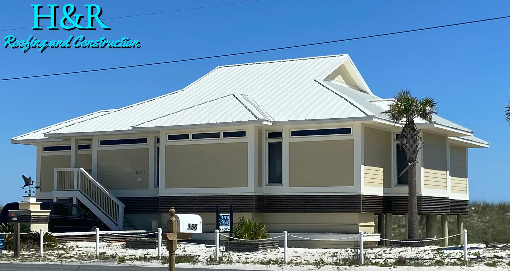 Completed white standing seam metal roof on beachfront stilt home on Navarre Beach FL by H&R Roofing and Construction